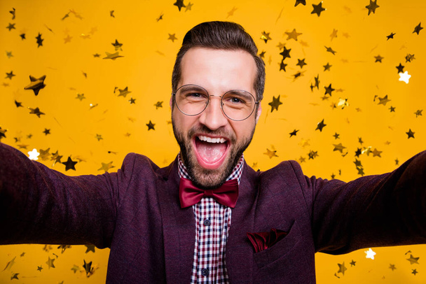 Closeup photo of cool crazy funky handsome stylish guy confetti fall making selfies social network blog new post party pic wear specs tie bow shirt blazer isolated yellow color background - Foto, afbeelding