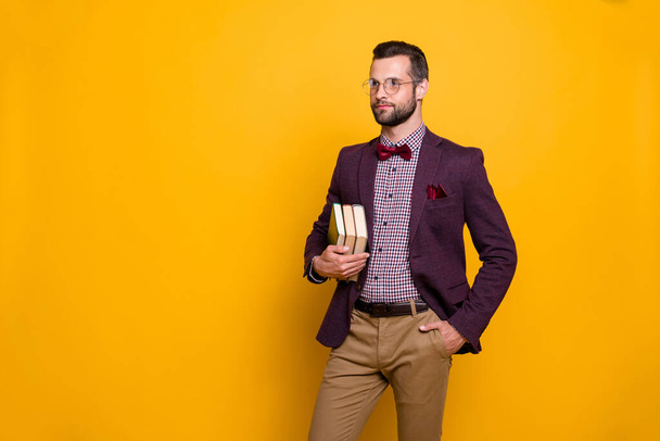 Portrait of his he nice attractive content intelligent guy holding in hands book academic business learning isolated over bright vivid shine vibrant yellow color background - Фото, зображення