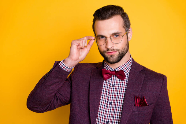 Close-up portrait of his he nice attractive content calm guy model wearing touching specs healthy look isolated over bright vivid shine vibrant yellow color background - Zdjęcie, obraz