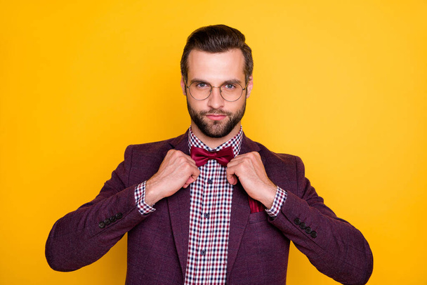 Closeup photo of handsome confident rich clothes guy business man hands fixing trendy neck tie bow not smiling wear specs plaid shirt blazer isolated yellow bright color background - Foto, afbeelding