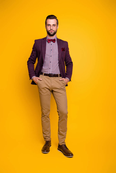 Vertical full length body size view of his he nice attractive content guy model macho posing holding hands in pockets isolated over bright vivid shine vibrant yellow color background - Photo, image