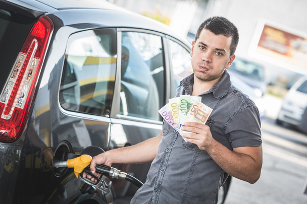 Man with Banknotes at Gas Station - Photo, Image
