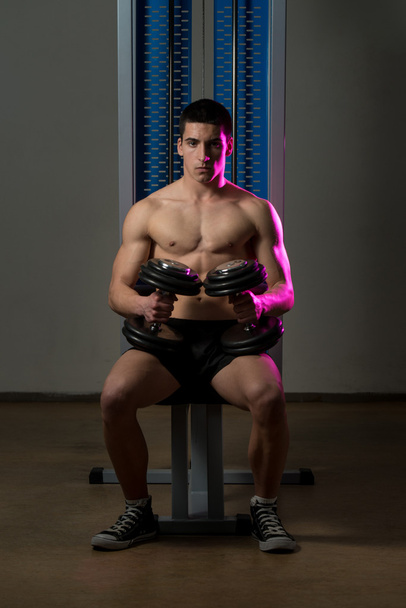 Young Men Exercising Biceps With Dumbbells - Foto, Imagen