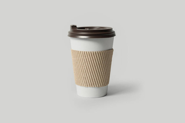 Takeaway paper coffee cup with cardboard sleeve on light grey background - Photo, image
