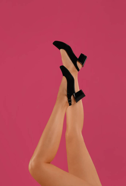 Woman wearing stylish shoes on pink background, closeup - 写真・画像