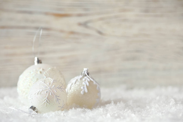 Beautiful Christmas balls on snow against blurred background. Space for text - Valokuva, kuva