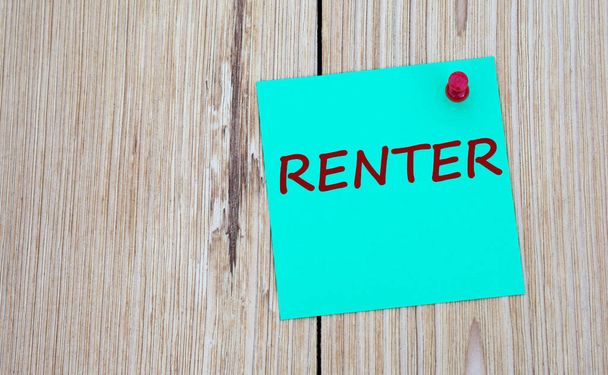 RENTER - word written on a green sheet for notes, which is pinned to a light wooden board. Business concept - Photo, Image