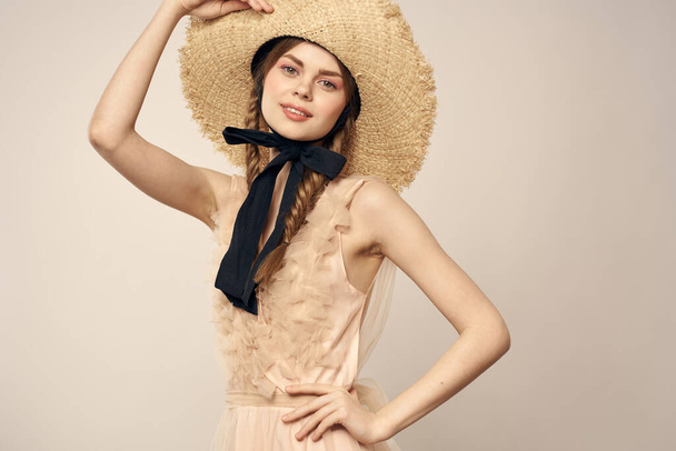 romantic girl in beige dress and in straw hat with black ribbon emotions portrait of model cropped view - Photo, Image