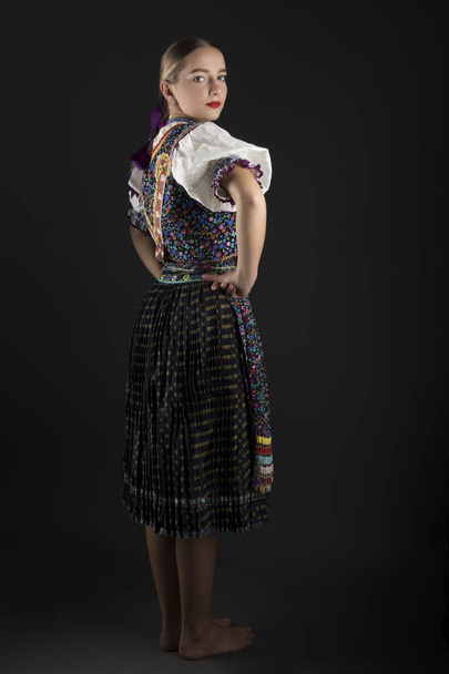 Young beautiful slovak woman in traditional costume. Slovak folklore. - Φωτογραφία, εικόνα