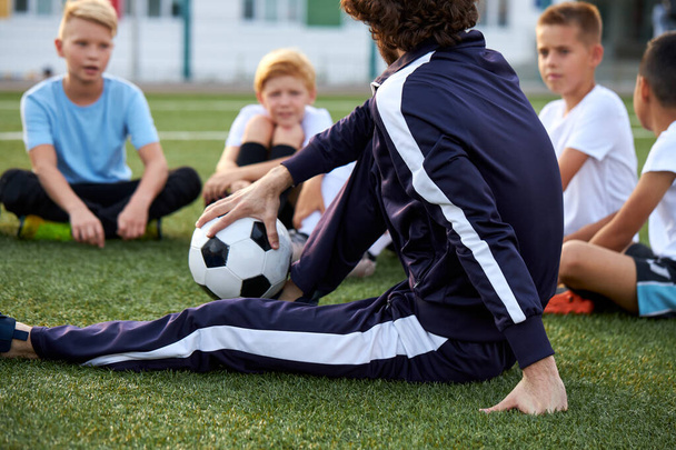 confident football trainer teach, instruct kids boys - Φωτογραφία, εικόνα
