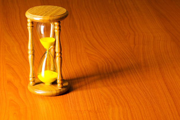 Time concept with hourglass against background - Photo, Image