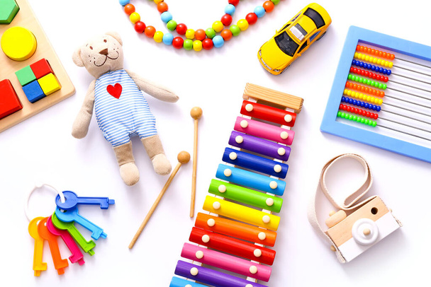 Colorful kids toys on white background. Top view, flat lay. - Photo, Image