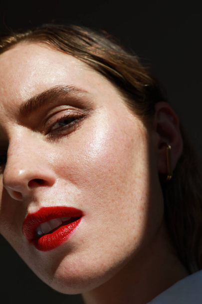Caucasian young woman with red lips. Vertical close-up of beautiful woman. - Foto, afbeelding