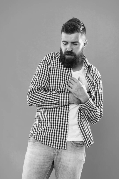 Symptoms of myocardial infarction. Heartache and chest pain. Healthcare. Preventing heart disease. Oh my heart. Bearded man suffer from heart pain. Hipster hold hand on heart. Cardiovascular health - Photo, Image