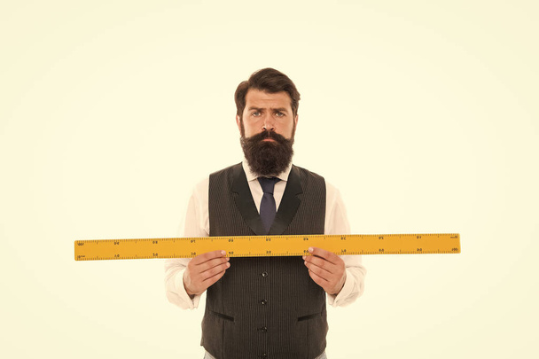 Measuring a line. back to school. bearded man hold ruler isolated on white. Teacher holding metric ruler. preparing for maths and geometry lesson. mature man with big measuring instrument - Photo, Image