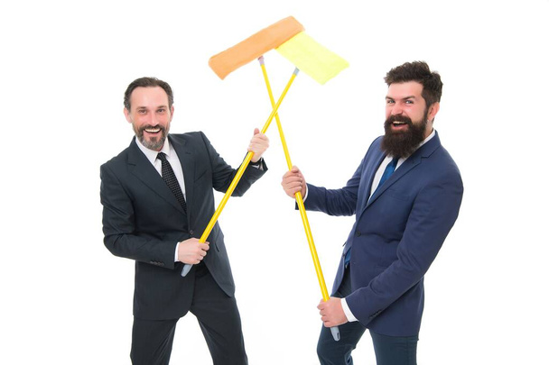 Cleaning service concept. Cover our tracks before someone find out financial fraud. Delete evidence. Clear reputation. Bearded men formal suits hold mops. Big cleaning day. Cleaning business - 写真・画像