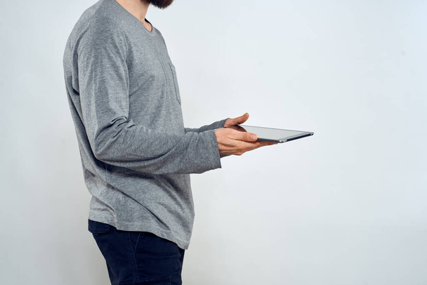 Man with tablet in hands technology lifestyle internet communication work light background cropped view - Foto, immagini