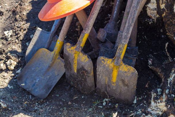 Background with shovels and tree stump. Manual uprooting of a tree. - Photo, Image
