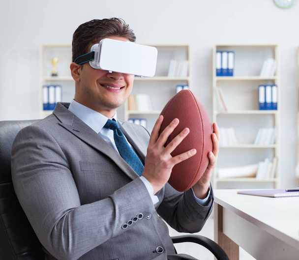 Businessman playing virtual reality football in office with VR g - Photo, Image