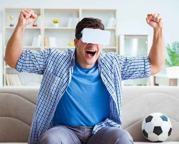 Man wearing virtual reality VR glasses watching soccer football - Photo, Image