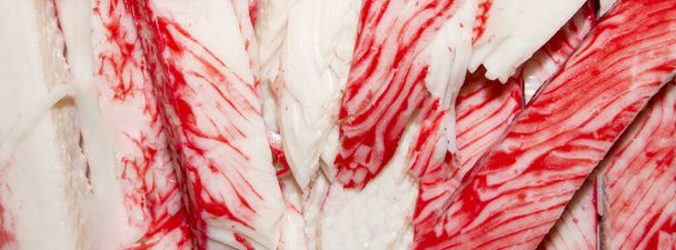 Crab stick.Background of crab meat.Crab sticks made from white fish meat. - Photo, Image
