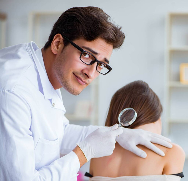Doctor examining the skin of female patient - Zdjęcie, obraz