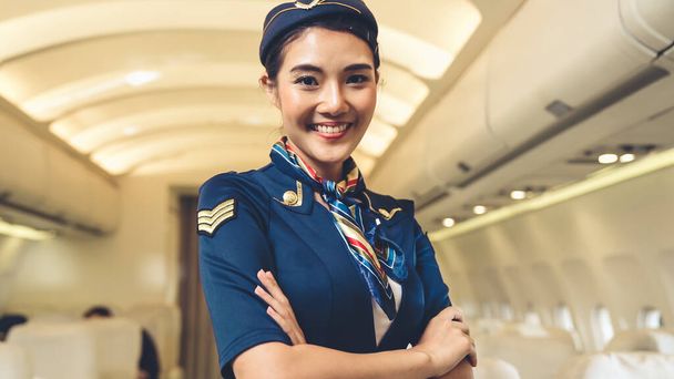 Cabin crew or air hostess working in airplane - Photo, Image