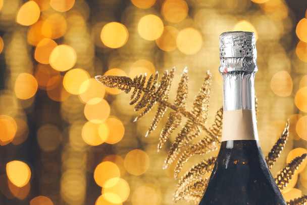 Bottle of champagne against blurred lights - Photo, Image