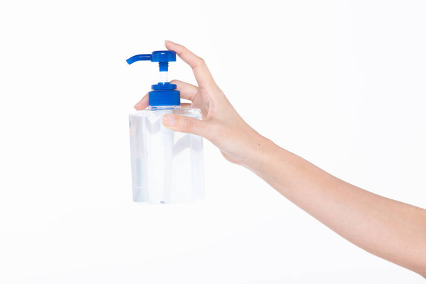New Normal People industry Lifestyle after Covid-19 Concept, woman hand held Sanitizer dispenser Alcohol 70% Gel pump bottle to wash and protect Coronavirus from carrier, isolated white background - Foto, imagen