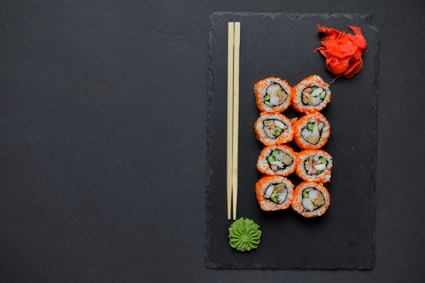Different Sushi rolls, sushi set rolled in cheese. California philadelphia sushi rools served on a black chalk board. Japanese cuisine concept. Copy space banner. - Photo, Image