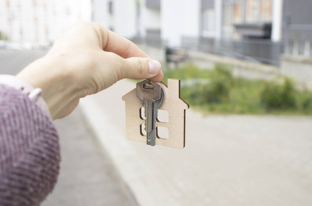 Female hand holding house key,real estate agent. - Fotografie, Obrázek