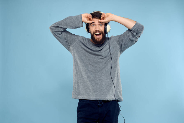man wearing headphones music emotion lifestyle modern style technology blue background - Photo, Image