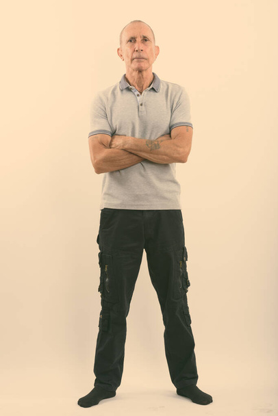 Full body shot of senior man standing with arms crossed - Photo, Image