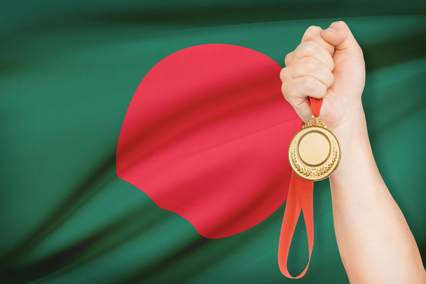 Medal in hand with flag on background - People's Republic of Bangladesh - Photo, Image