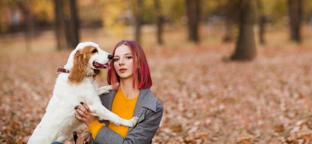 Young woman with her dog in the park. - Photo, Image
