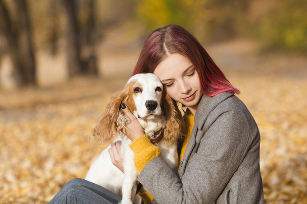 Young woman with her dog in the park. - Photo, image