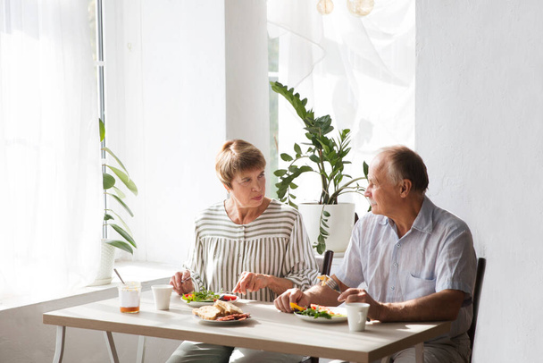 Elderly couple having breakfast together. - Fotó, kép