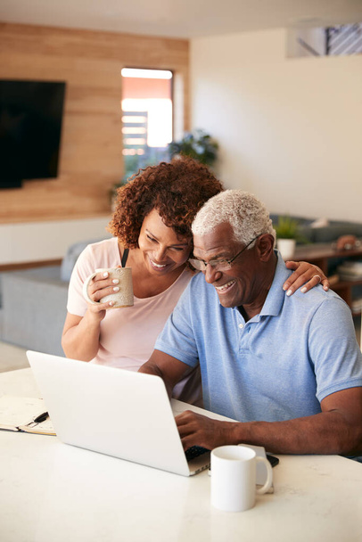 Senior African American Couple Using Laptop To Check Finances At Home - Фото, изображение