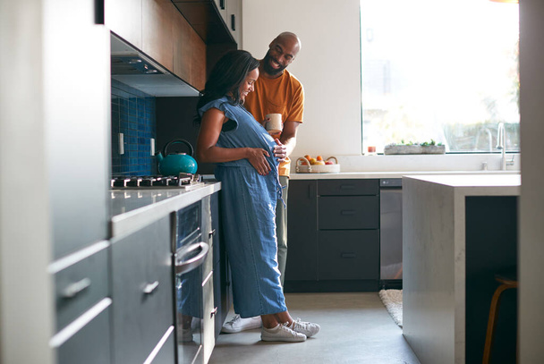 Loving African American Husband With Pregnant Wife At Home In Kitchen Together - Foto, Bild