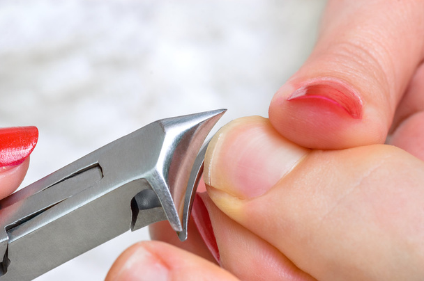 cutting fingernail with clipper - Foto, Imagen