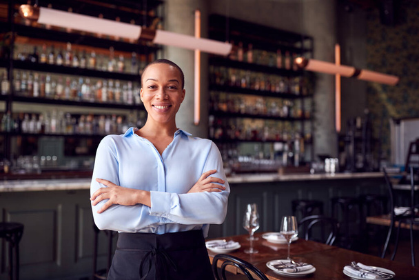 Portrait Of Confident Female Owner Of Restaurant Bar Standing By Counter - Фото, зображення