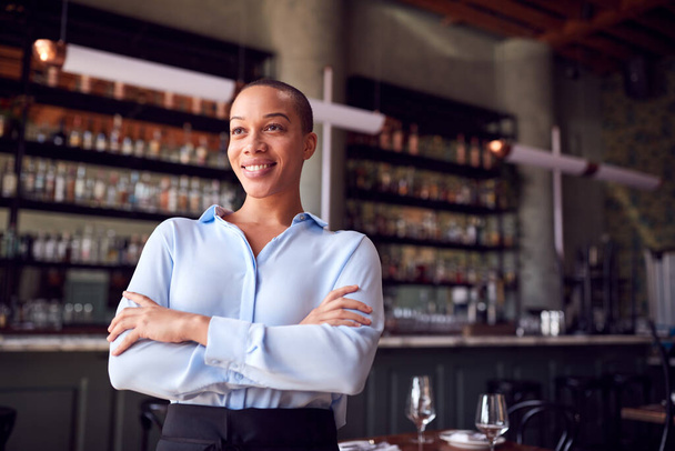 Portrait Of Confident Female Owner Of Restaurant Bar Standing By Counter - Foto, Imagen