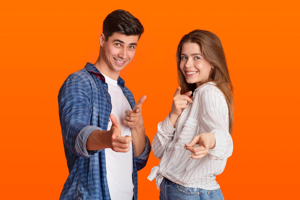 Funny lucky millennial man and woman point fingers at camera and rejoice to success after win at good day - Photo, Image