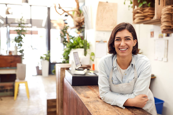 Portrait Of Smiling Female Sales Assistant Standing Behind Sales Desk Of Florists Store - Φωτογραφία, εικόνα