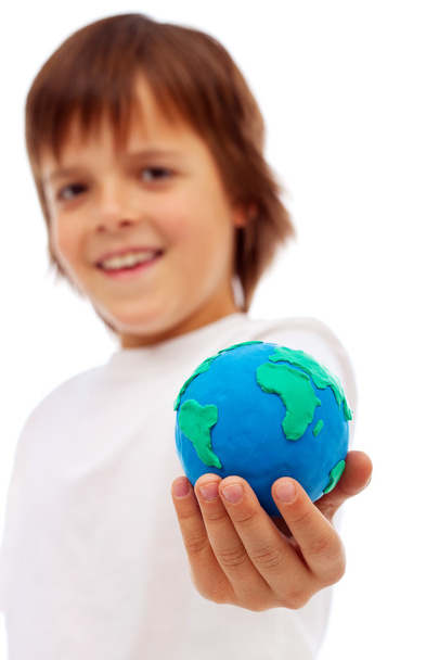 Smiling boy holding modelling clay earth - 写真・画像