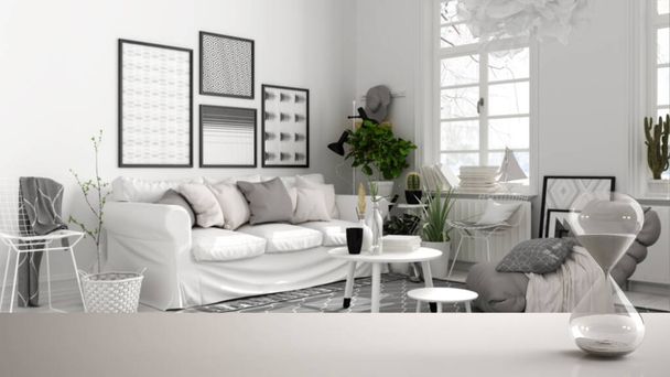 Білий стіл або полиця з кришталевим пісочним годинником, що вимірює час скандинавської чорно-білої вітальні, дивана, килима, архітектурного дизайну інтер'єру, копіювання простору фону
 - Фото, зображення