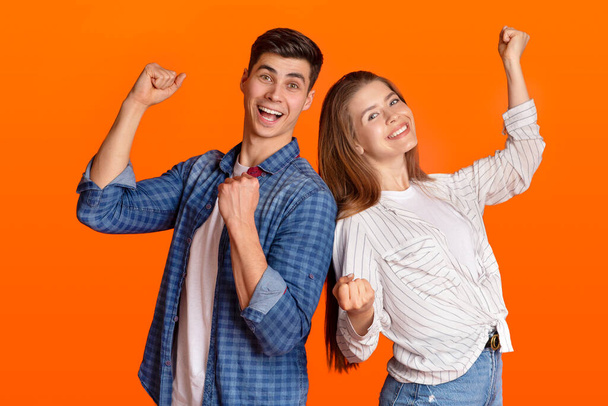 Happy guy and lady in casual clothes celebrate winning and express emotions of fun - Фото, зображення
