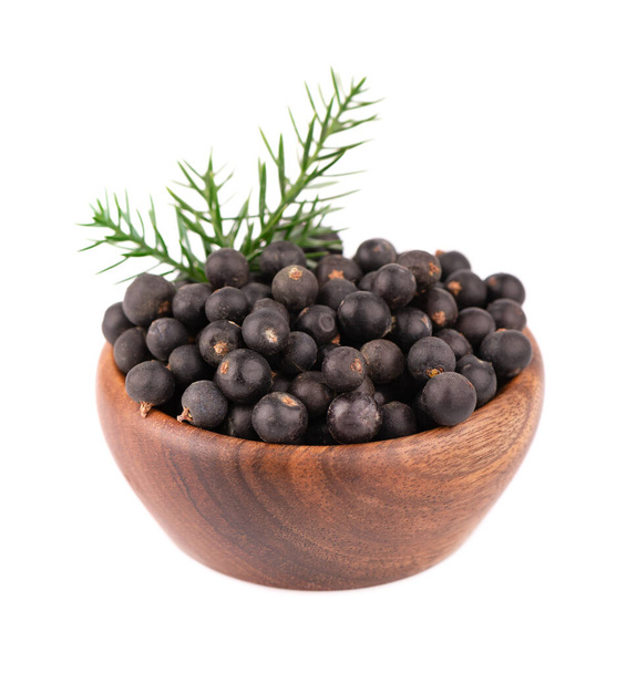 Dry juniper berries in wooden bowl, isolated on white background. Common Juniper fruits - Photo, Image
