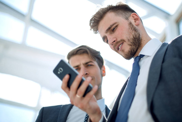 close up.business colleagues looking at the smartphone screen. - Foto, imagen