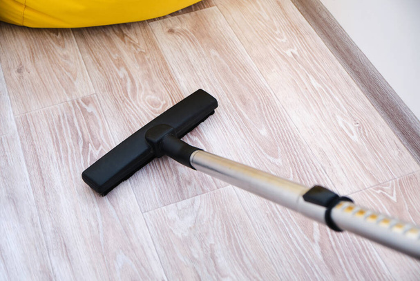 Head of modern vacuum cleaner cleaning the floor. Top view. - Zdjęcie, obraz